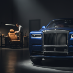 A luxurious Rolls-Royce Phantom reflecting light in a high-end showroom